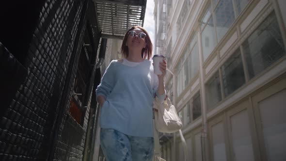 Attractive Young Lady Happily Walking on Urban City Street Tourist with Coffee