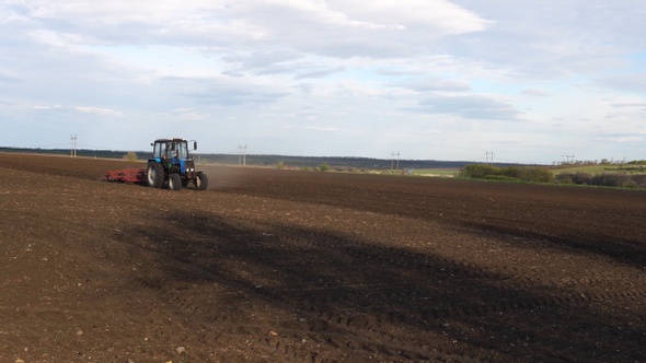 Tractor plows the farm field