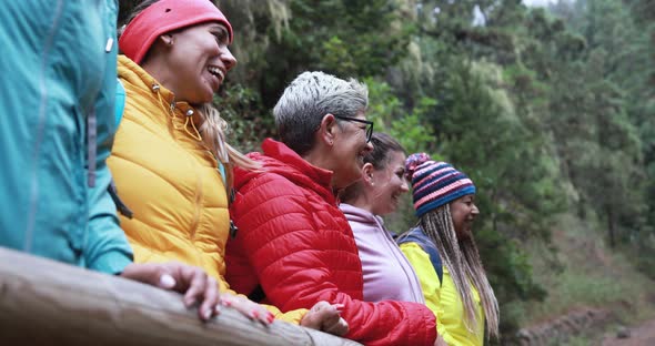 Multiracial women having fun during trekking day in to the wood