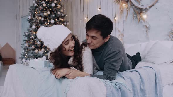 Portrait of a Young Couple Spending Time at Home in the Living Room on Christmas Eve