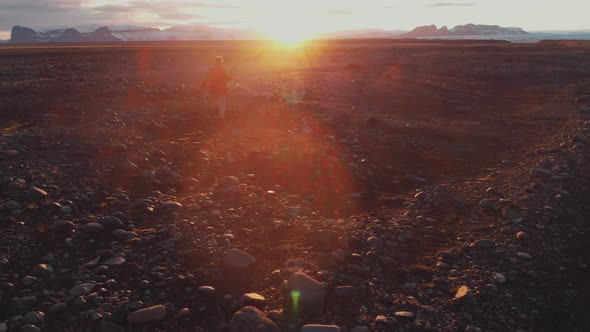 Man running on rocky ground in mountains