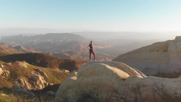 Woman looks out over canyon