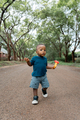 African boy with a toy walking alone in the street - PhotoDune Item for Sale
