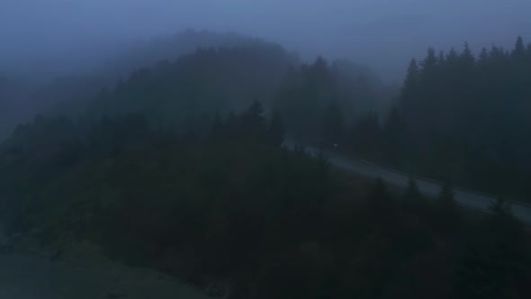 Aerial View of the Grayish Skyline Above the Picturesque Highway with Cars