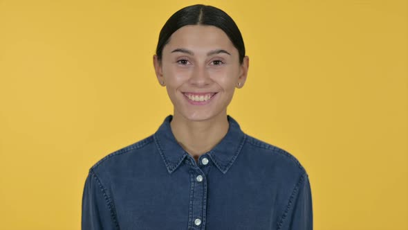 Smiling Latin Woman Yellow Background