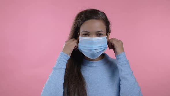 Pleased African Woman Removed Protective Mask and Throws It on Floor As Symbol of Pandemic Epidemic