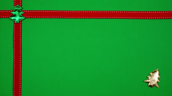 Red Ribbon and Bright Christmas Tree Decorates the Edges of Green Background. Stop Motion