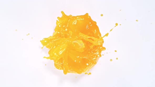 Super Slow Motion Shot of Orange Juice Vortex Splash Isolated on White Background at 1000Fps