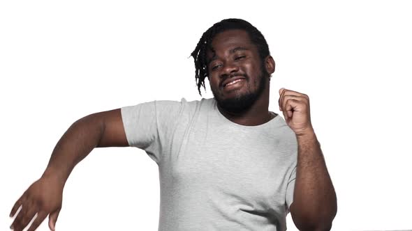 Portrait of Happy African Man Having Stylish Afro Hairdo and Mustache Dancing with Arms While