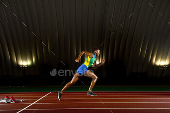 Young woman sprinting in stadium