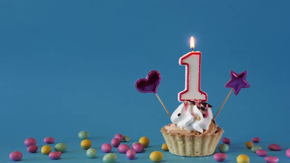 Happy Birthday Greetings to 1 Year Old Baby Birthday Cupcake with Candles and Birthday Decorations