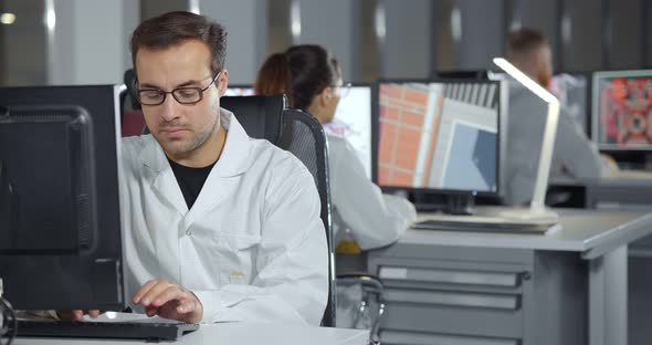 Technicians Working on Desktop Computers in Modern Lab