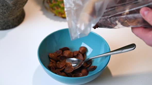 Person Pouring Up Cereal In A Bowl