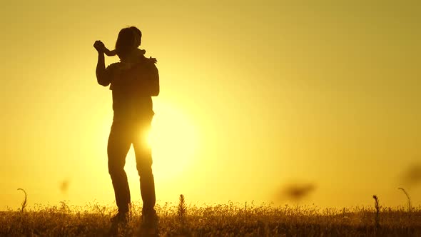 Concept of a Happy Childhood. Dad Is Dancing with a Child in Her Arms in Field in Sun