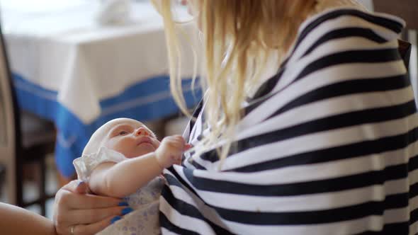 Mother with baby daughter in hands