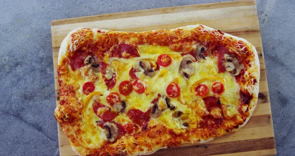 Baked pizza on wooden board