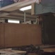 carpenter running wood through a saw machine - VideoHive Item for Sale