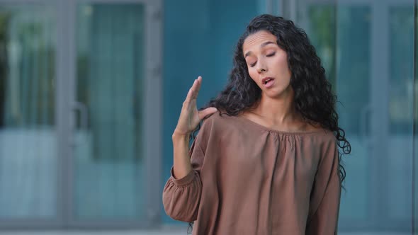 Portrait Outdoors Hispanic Bored Woman Disappointed Girl Looking at Camera Showing Blablabla Hands