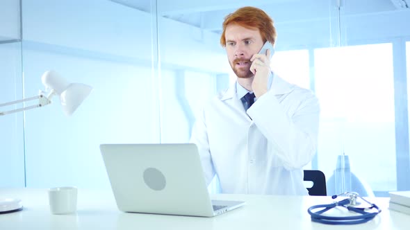 Doctor Talking on Phone in Hospital, Redhead