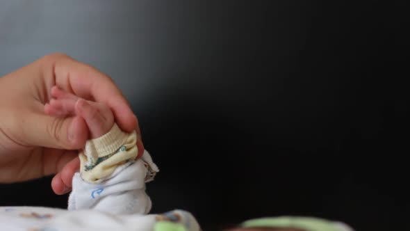 Dad Holding Newborn Baby's Hand