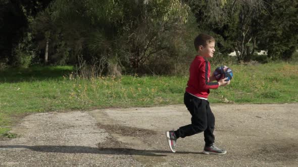 Footage of caucasian boy, doing basket ball exercises, during coronavirus lockdown ,at fields of Par