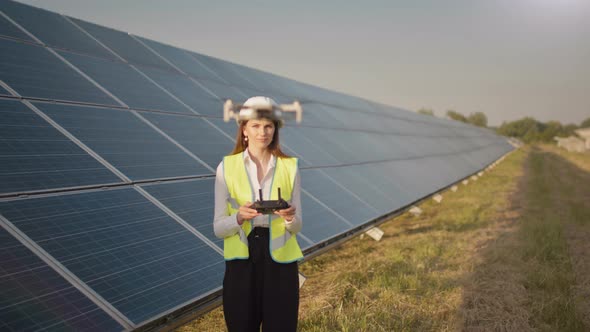 Engineer Woman in Hardhat Holding Tablet Computer Operating Flying Drone in