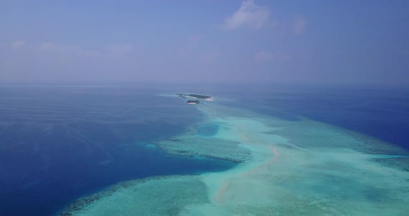 Wide flying clean view of a sandy white paradise beach and aqua turquoise water background in best q