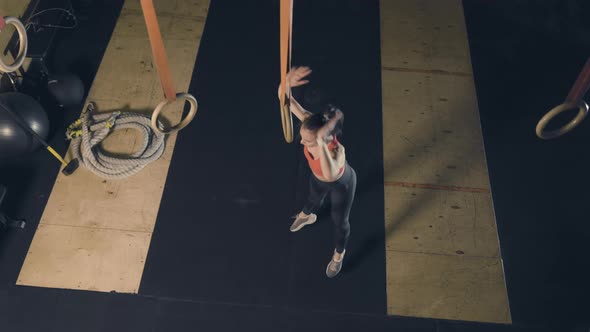 Young Woman Doing Burpee in Gym