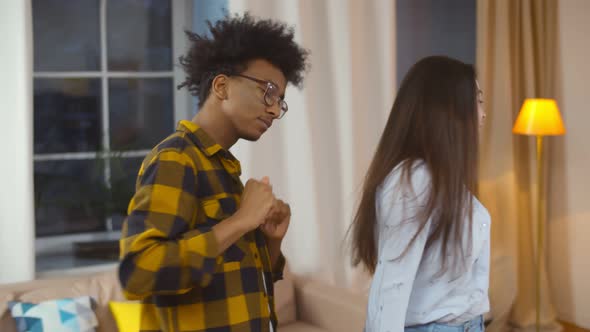 Lovely Multiethnic Young Couple Dancing Together at Home