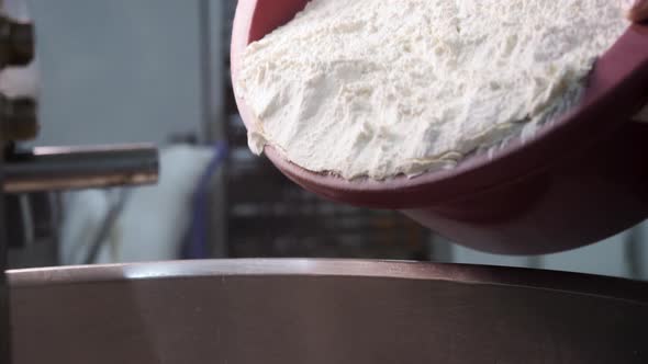 White Flour Falling Down From The Plastic Bowl