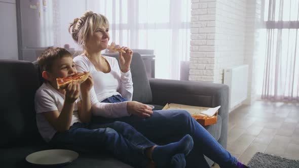 Happy Family Watching Comedy and Having Snack