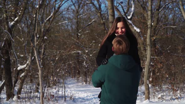 Happy Couple Having Fun in Winter Forest