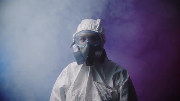 A Woman in Protective Medicine Suit in Smoky Room