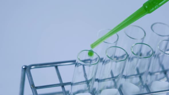 Scientist is preparation the green chemical solution in test tube in the laboratory experiment.