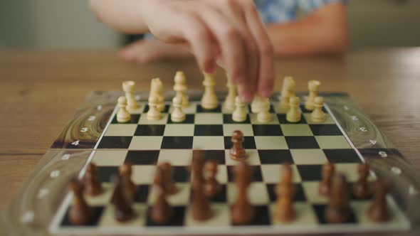 Young Man Wearing Glasses Plays Chess Alone With Himself At Home