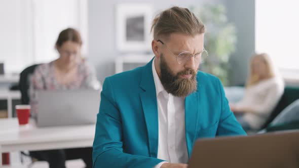 Man Working on Laptop in Office