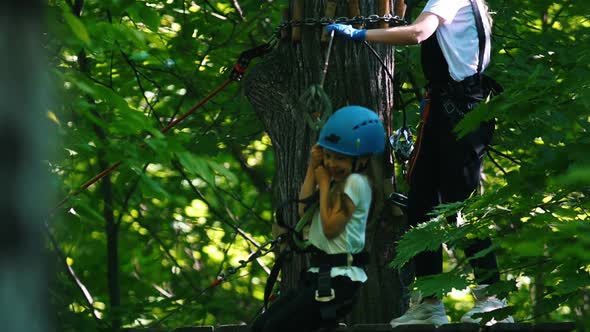 A Woman with Her Little Daughter Having a Rope Bridge Entertainment in Full Insurance