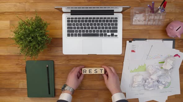 Word Rest is Made From Cubes with Hands on the Office Table