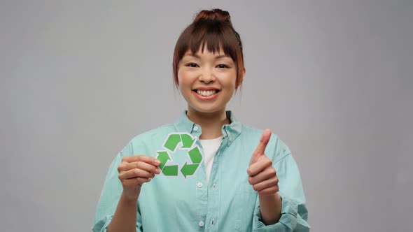 Asian Woman with Recycling Sign Showing Thumbs Up