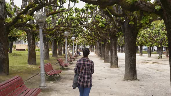 Woman traveler walking in Manuel Braga park in Coimbra, Portugal