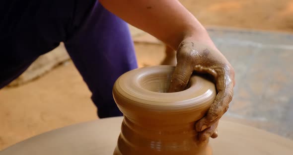 Skilled Hands of Potter Shaping the Clay on Potter Wheel and Sculpting Clay Pot Jar. Udaipur