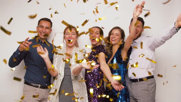 Happy Friends Under Golden Confetti at Party