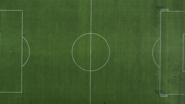 Top View of a Football Field with Green Grass Outdoors in Summer