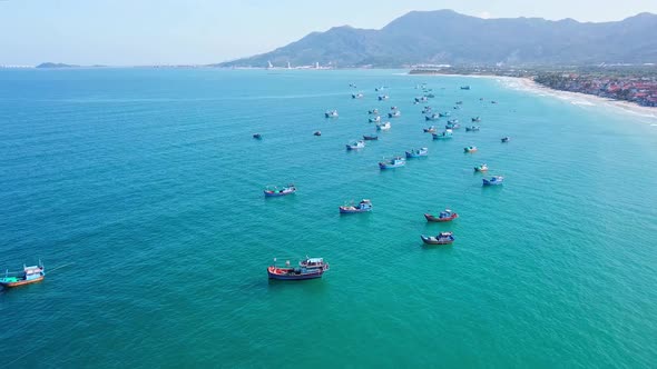 Aerial Footage of Different Multicoloured Fishing Boats in Blue Ocean Water