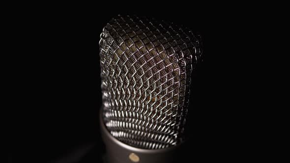 Studio Condenser Microphone Rotates on Black Background