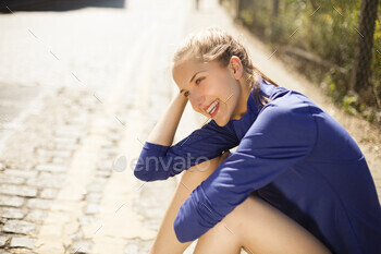 Runner resting on pavement