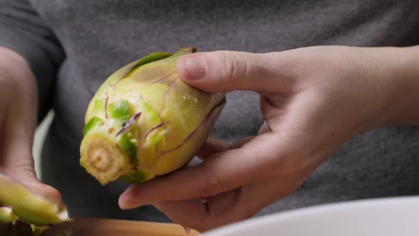 Woman Cleaning Artichokes