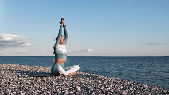 Relaxed Sportswoman Meditating on Sunset Beach Lotus Position Prayer Asana Feeling Harmony Balance