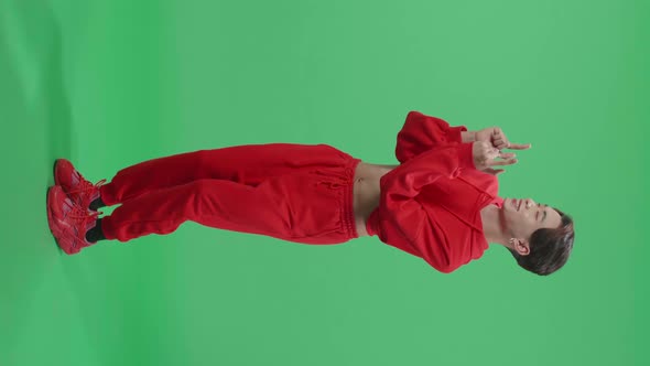 Full Body Of The Smiling Asian Transgender Male Dancing Sides While Standing On Green Screen