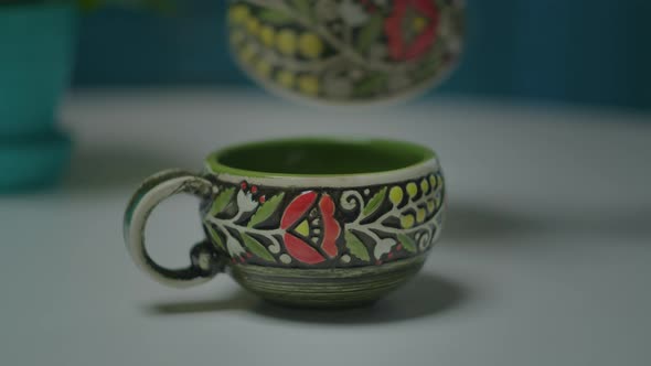 Close Up of Pouring Black Coffee Into Porcelain Coffee Cup on the Table